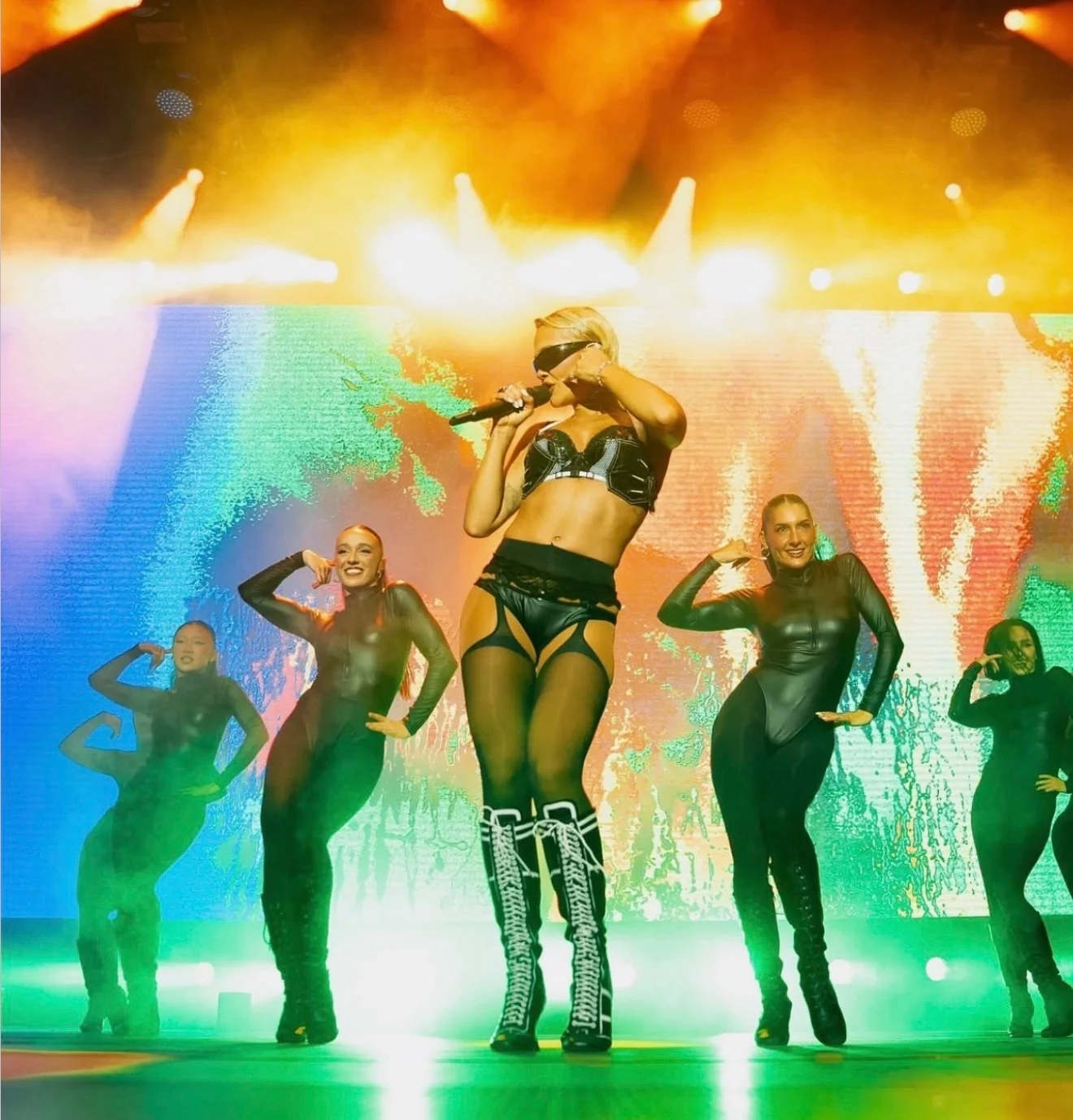 Rita Ora performing on stage, hair by Mya