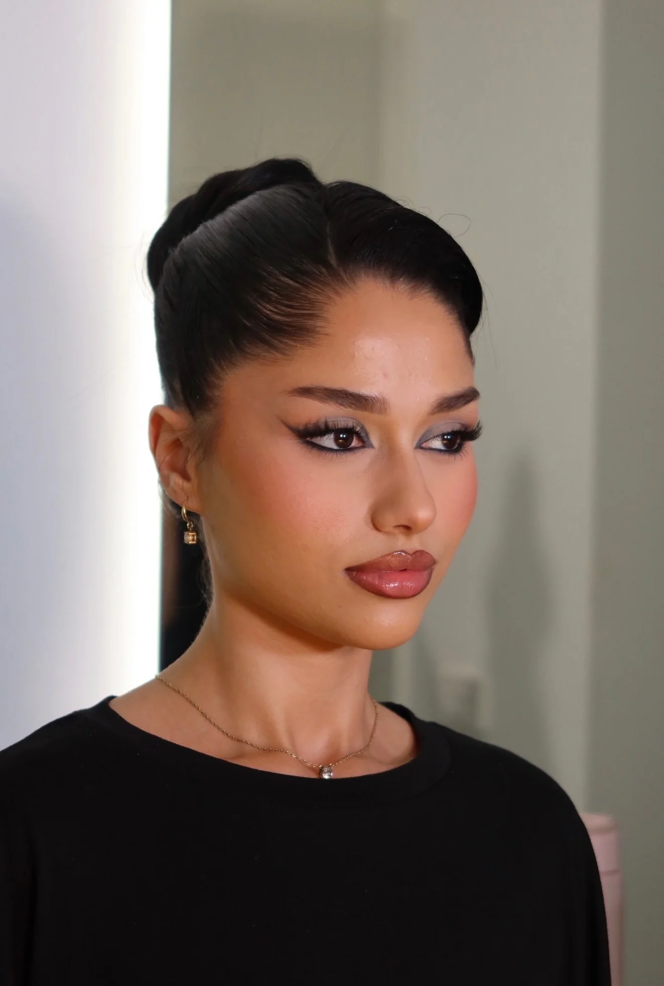 Sleek dark bun, profile